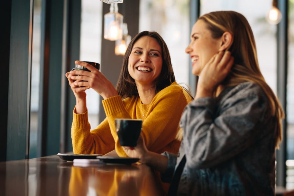 Two ladies enjoying a coffee in a cafe