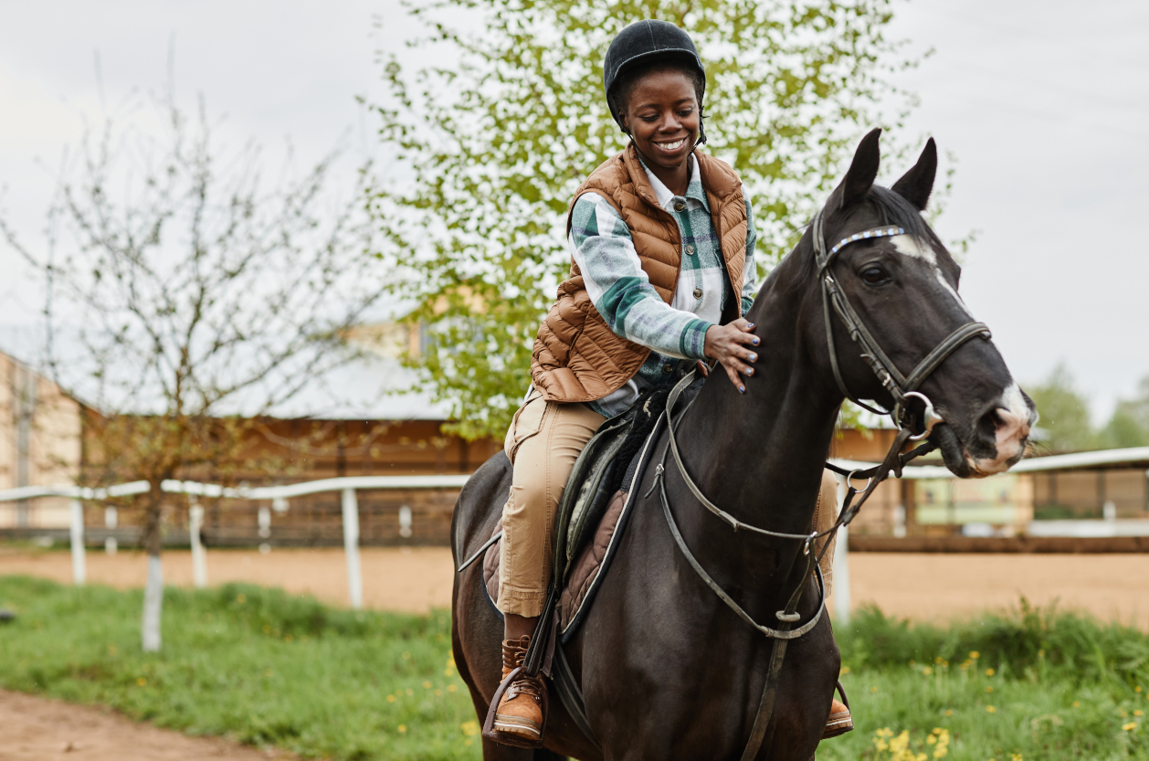 Woman Riding Horse at Country Farm