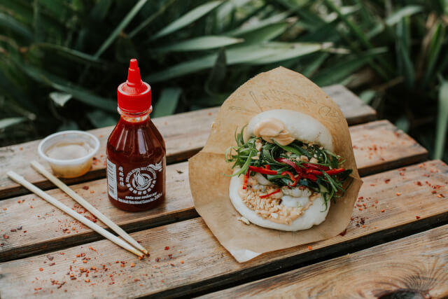 a bao bun and hot sauce