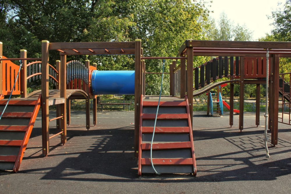 a empty playground with a climbing frame