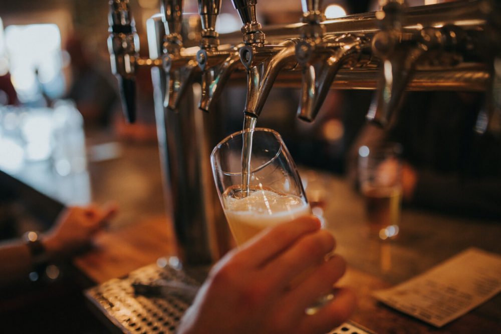 bartender pouring drink at pub