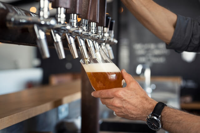 bartender pouring pint of lager