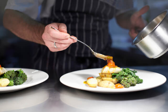 chef plating up seafood dish