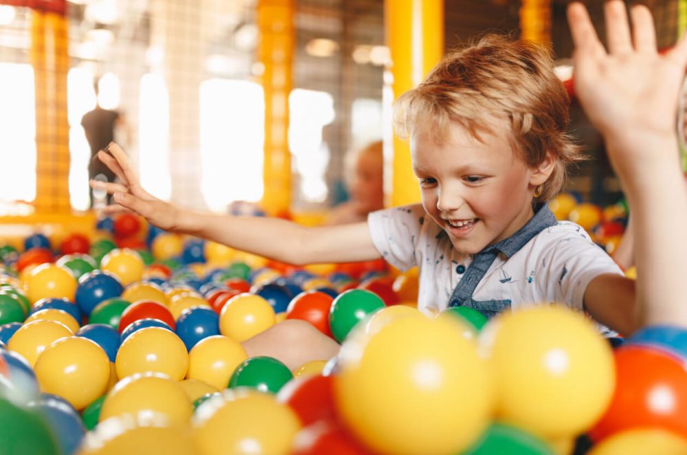 child playing in ball pit