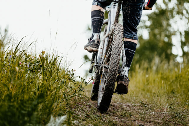 close up of man cycling on muddy track