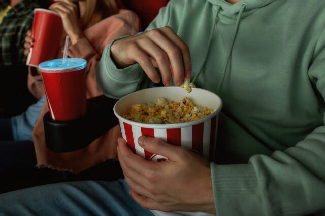 close up of man eating popcorn