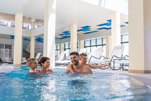family in indoor swimming pool