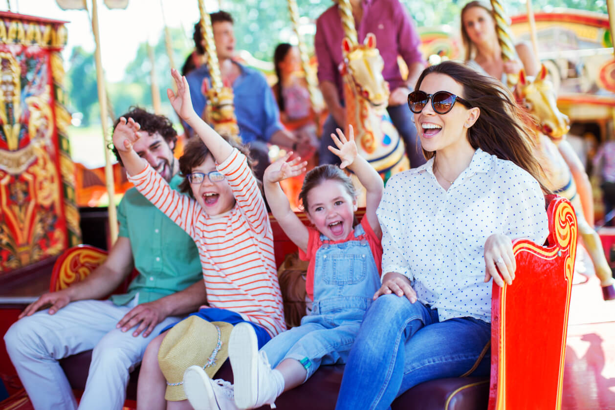 famkily of four enjoying fairground ride