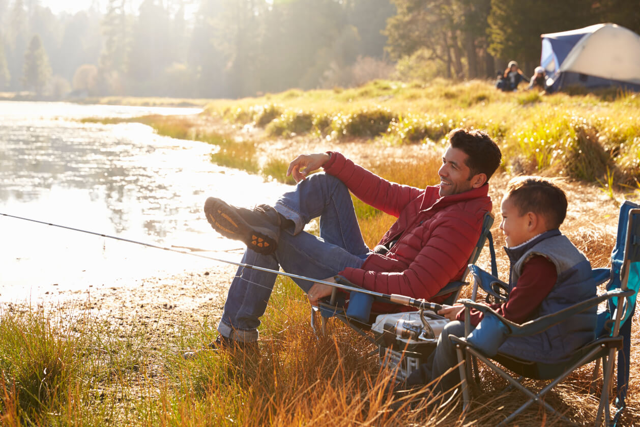 father and son fishing at a lake