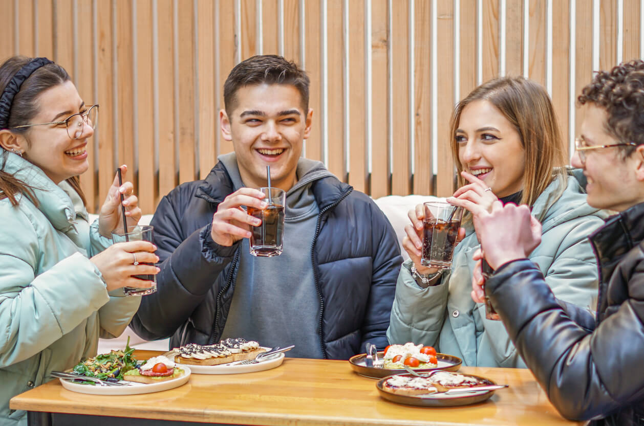 group of 4 friends enjoying a meal out