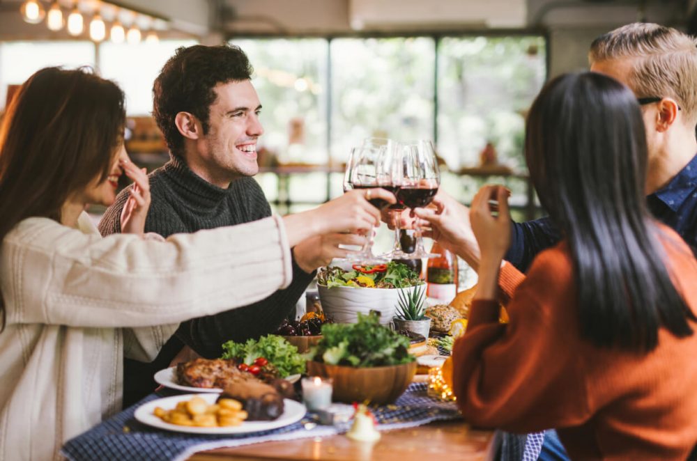 group of adults enjoying a meal during the day