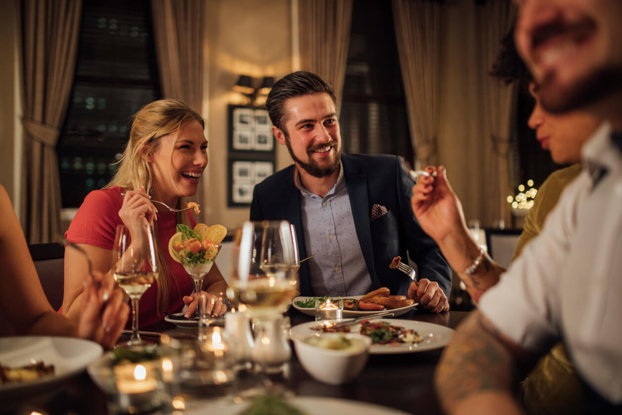 group of adults enjoying a meal in a sophisticated setting