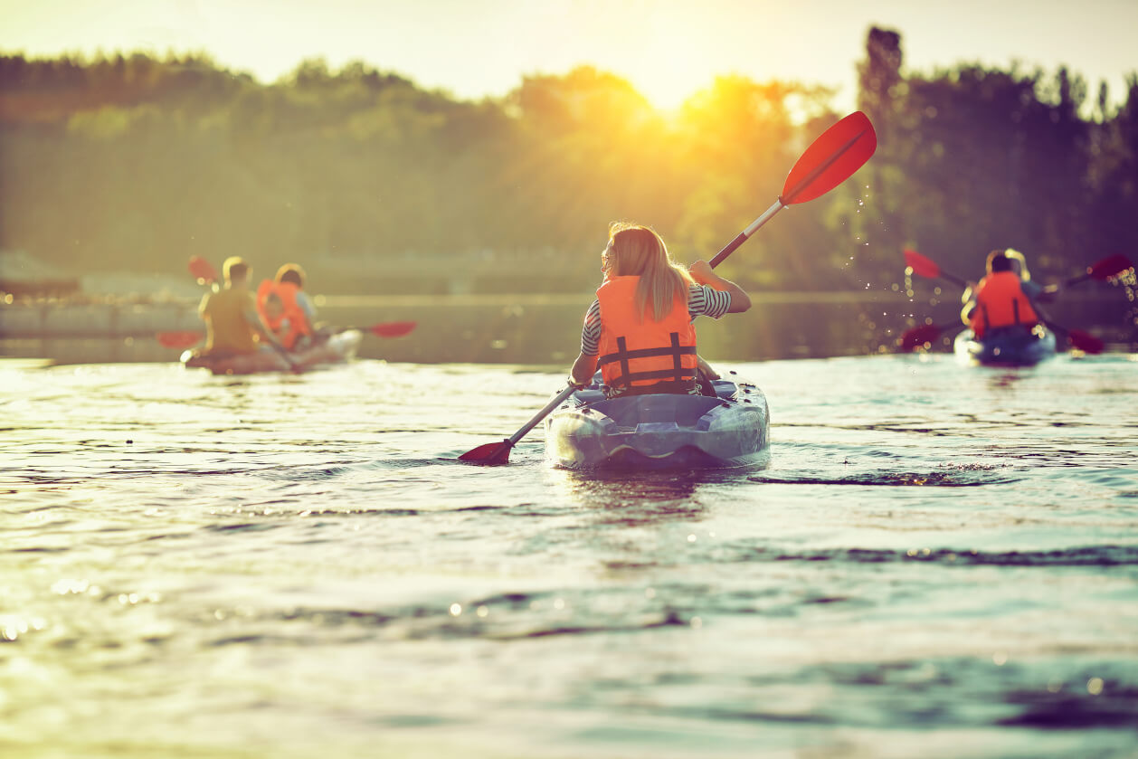 group of friends kayaking on a lake