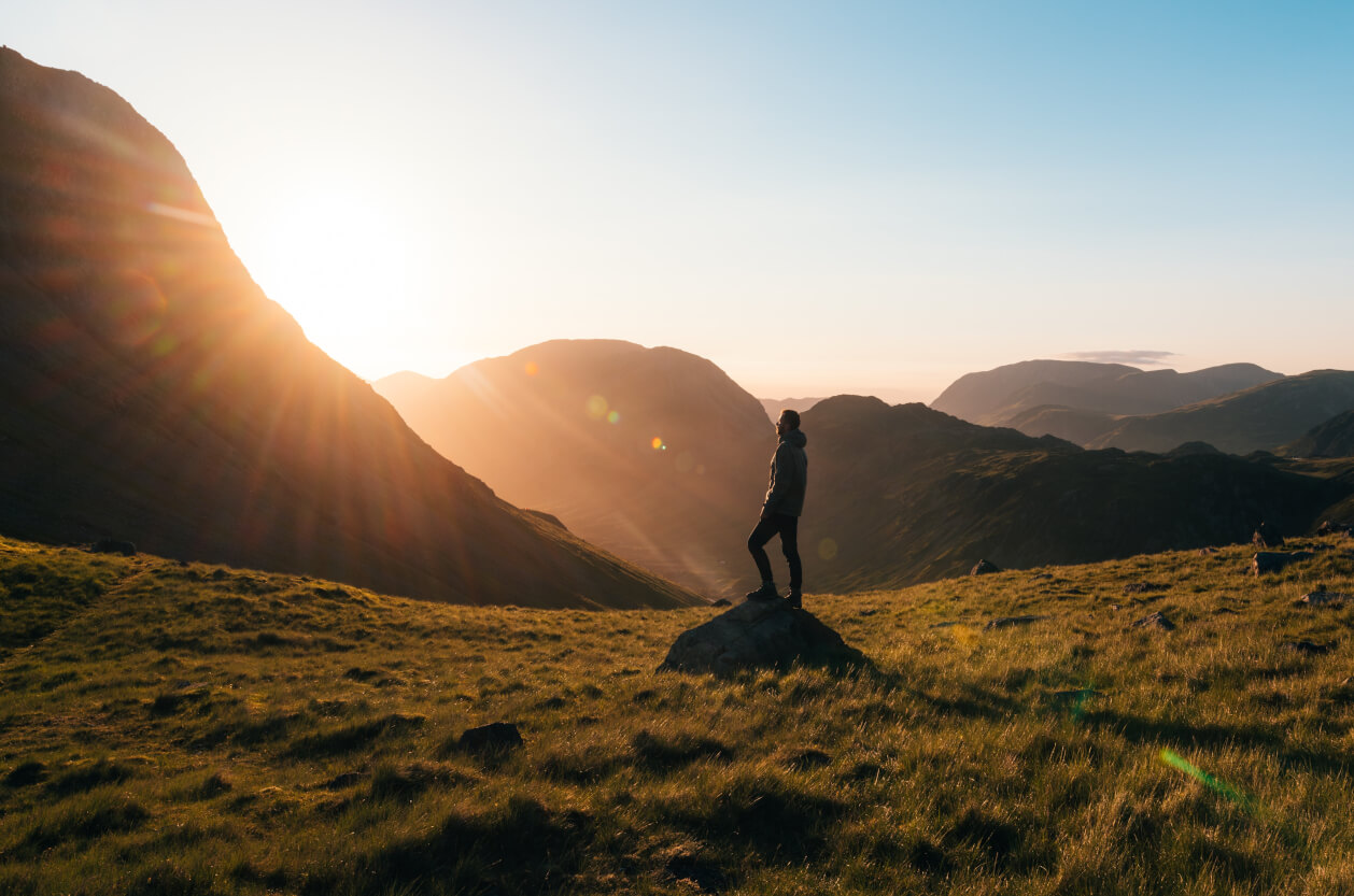 hiker in the mountains at sunset