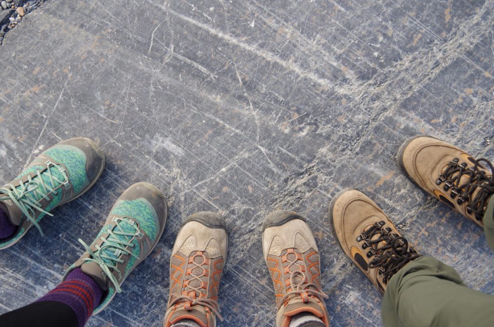 hikers in a circle wearing hiking boots