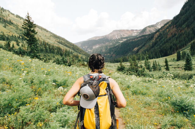 lady hiking through valley