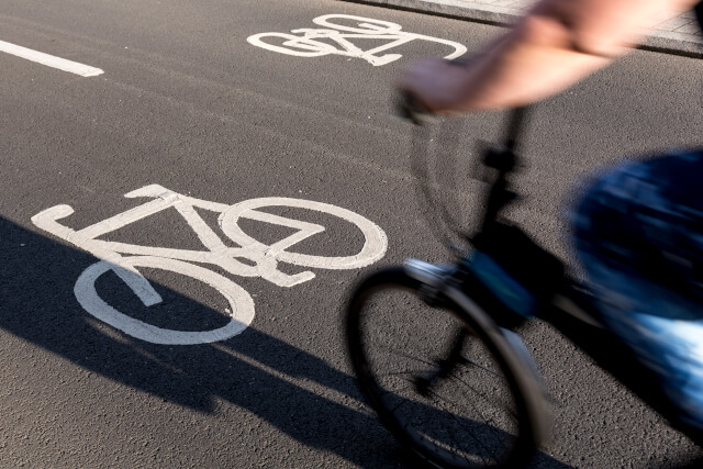 man cycling on assigned bike path