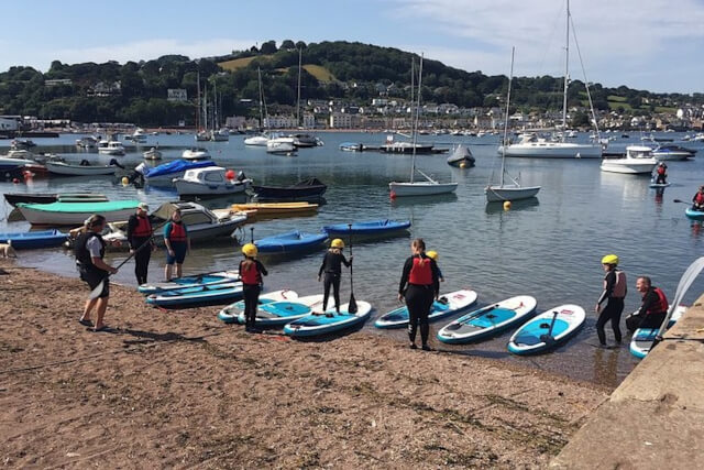 paddleboarders at polruan back beach