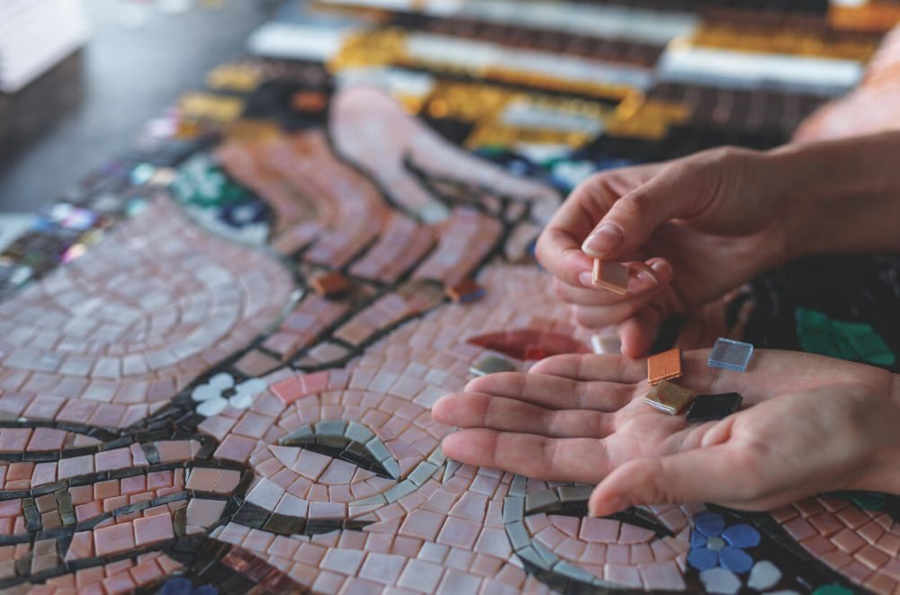 person working on mosaic