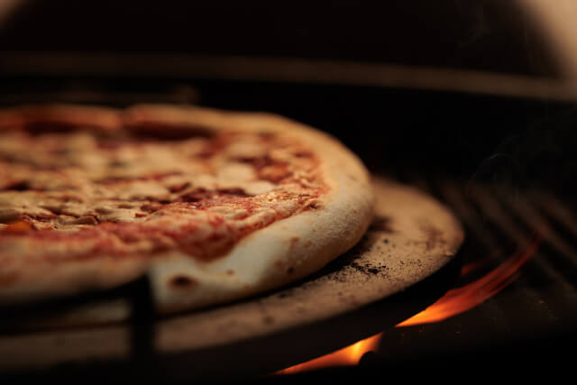 pizza cooking in an oven