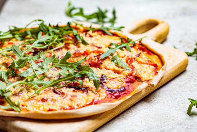 pizza served up on a wooden board