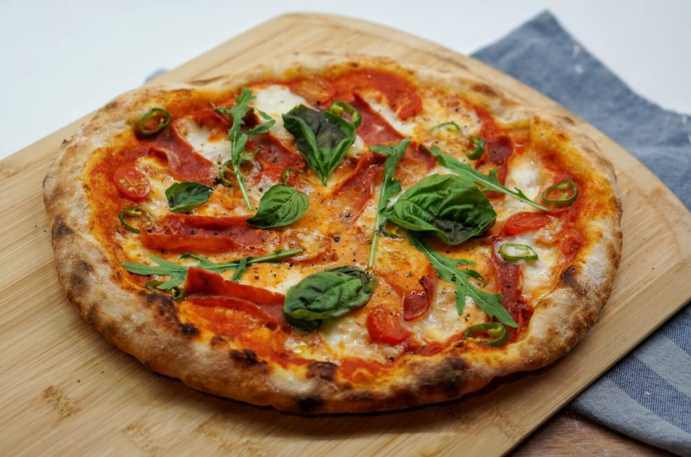 stone baked pizza on a board