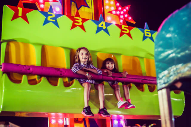 two kids on a theme park ride