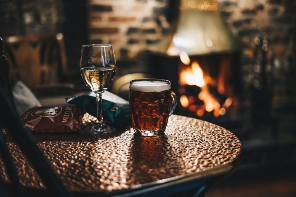 wine, beer, crisps in cosy pub with fire