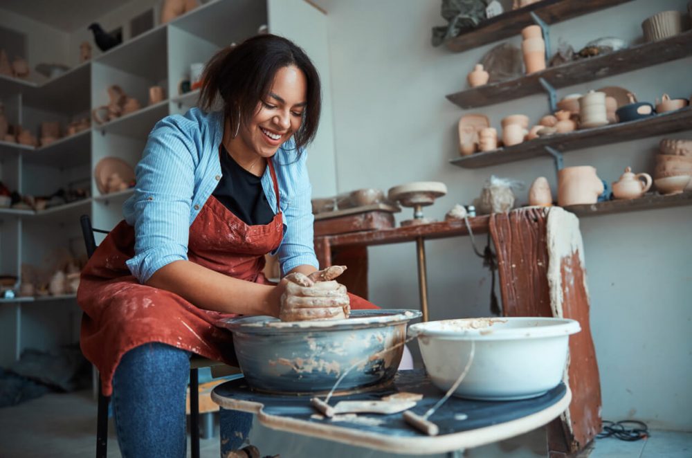 woman throwing pottery