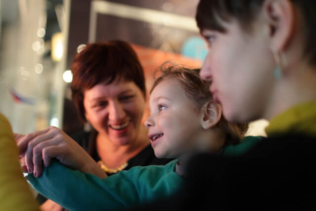 woman with two children at museum